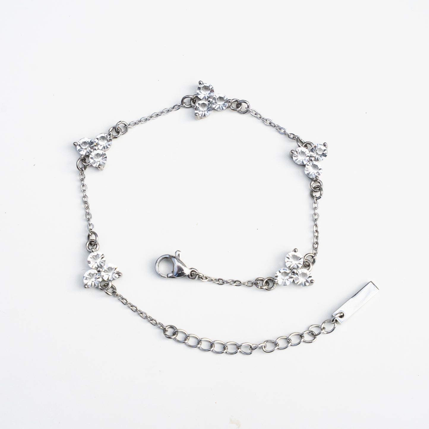 Silver bracelet with gemstones on a white background
