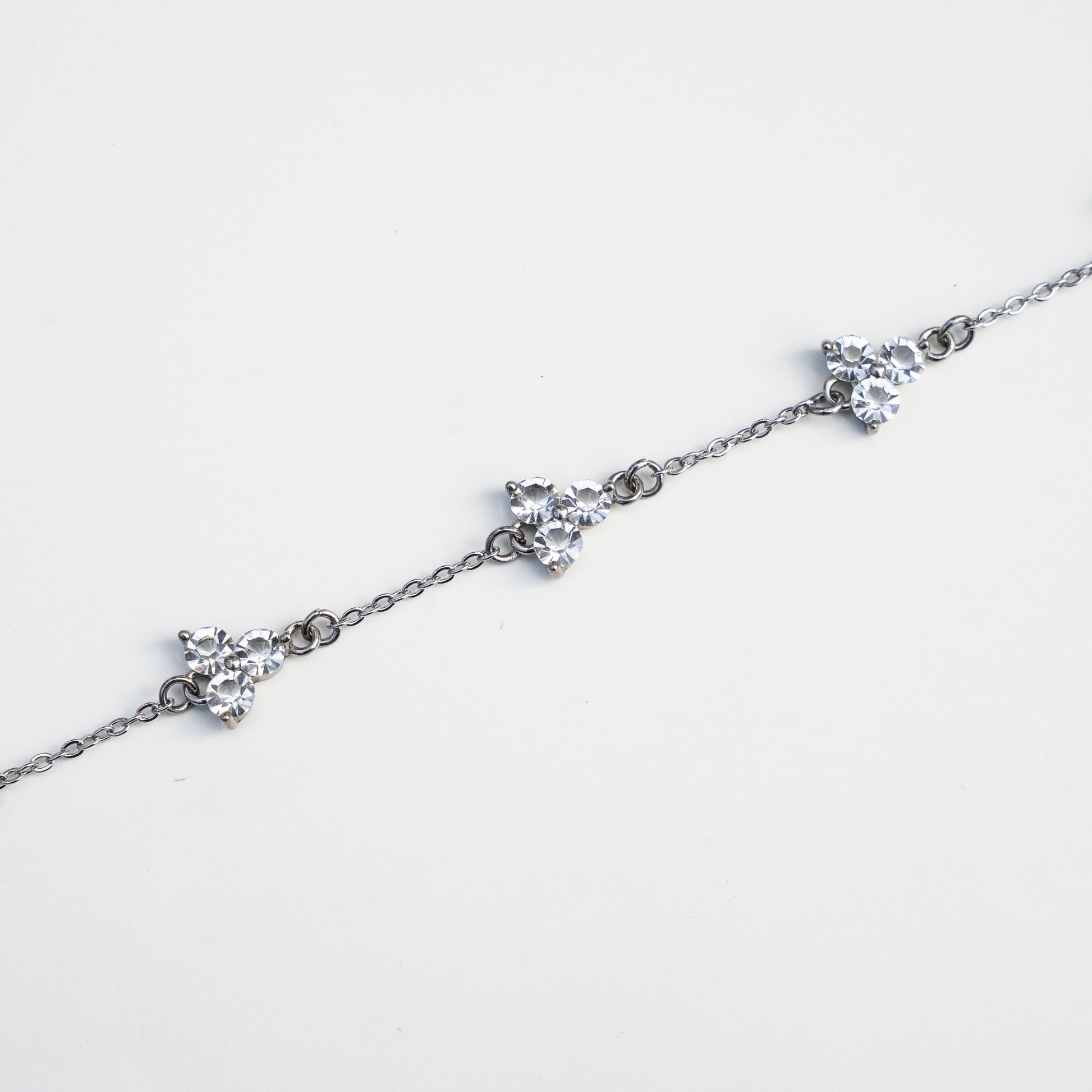 Silver bracelet with gemstones on a white background