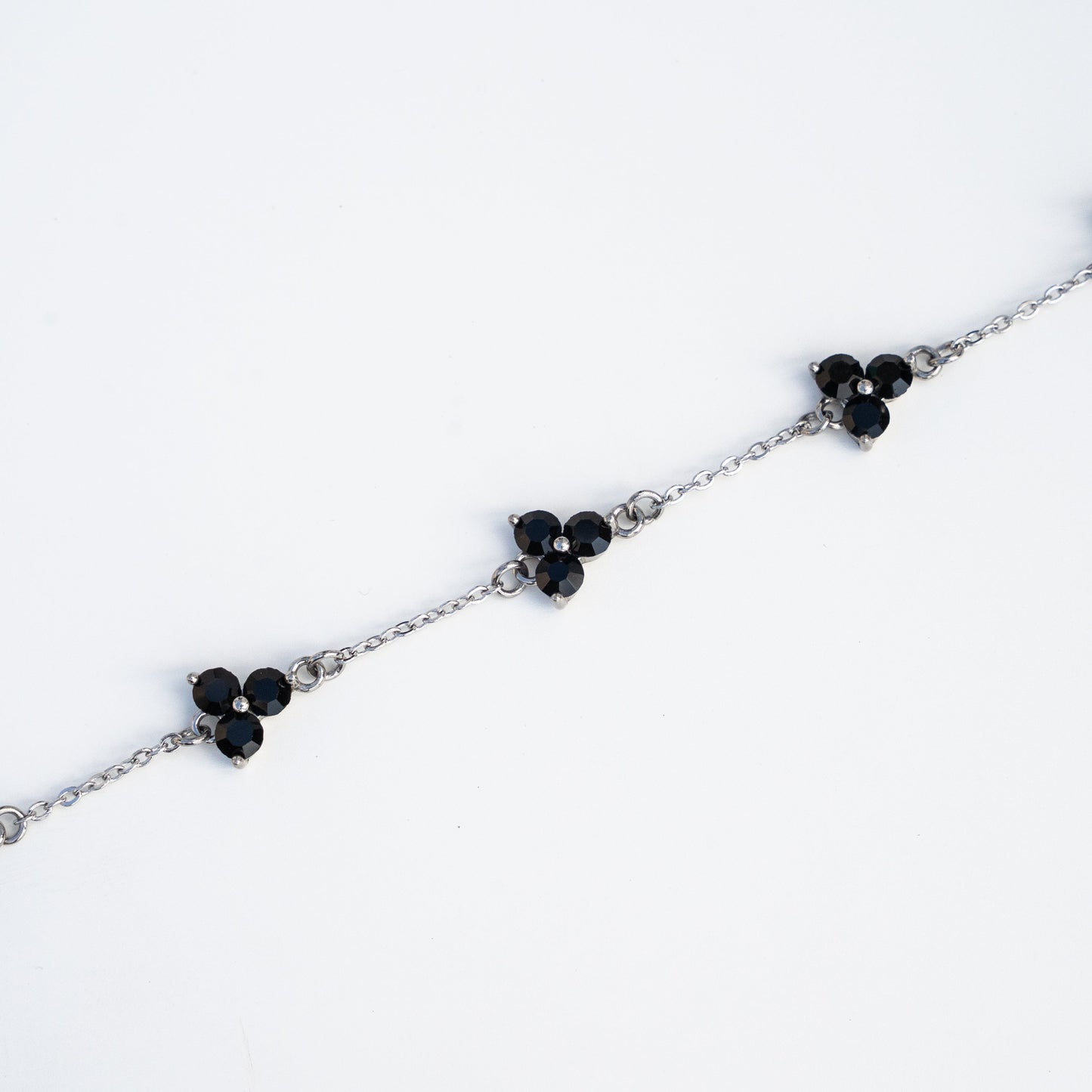 Silver bracelet with gemstones on a background