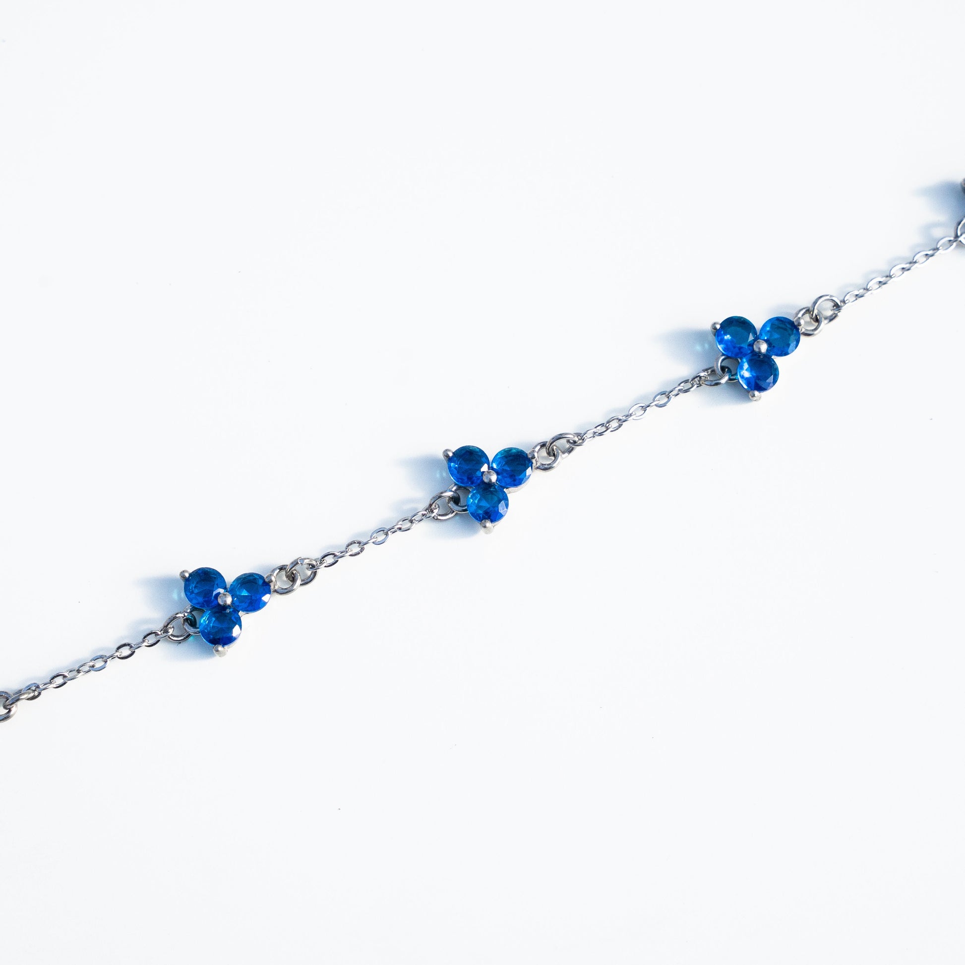 Silver bracelet with blue gemstones on a background