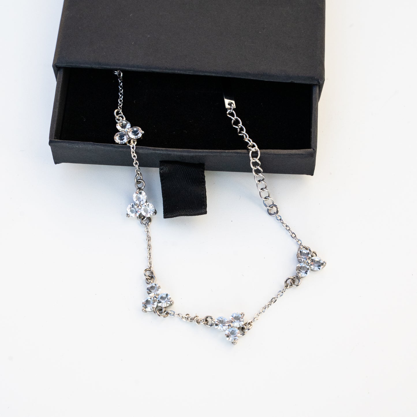 Silver necklace with dimond like on a white background